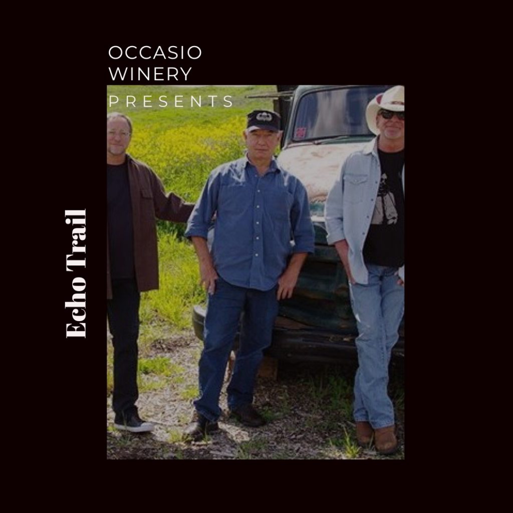 a picture of the band members echo trail standing in a field in front of an old truck