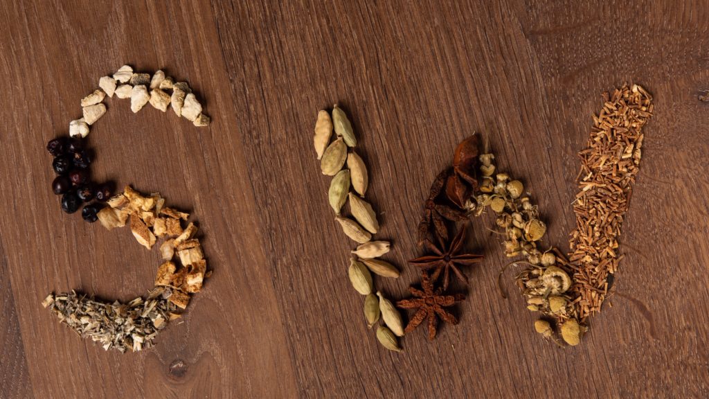 Letters S W traced out with spices used in making Gin