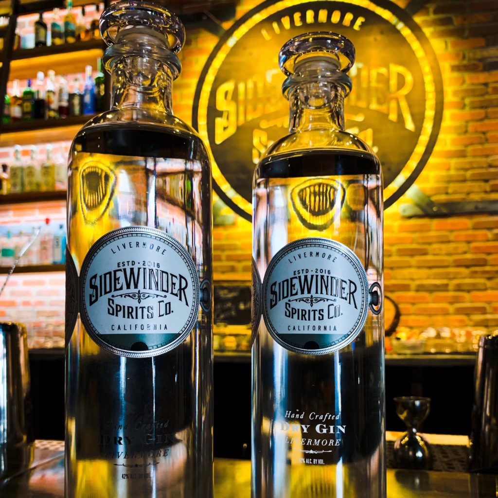 picture of two bottles of Sidewinder Dry Gin on a bar