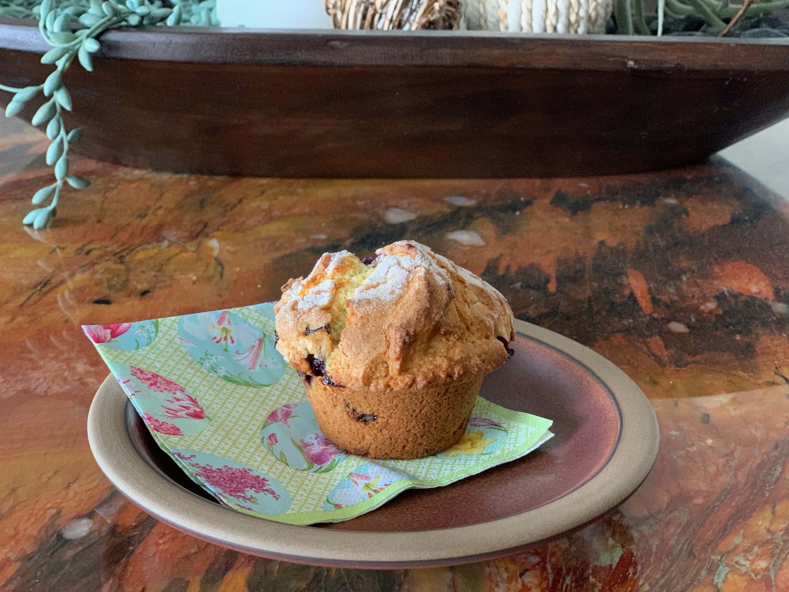 blueberry muffin on a Easter themed napkin and a brown plate