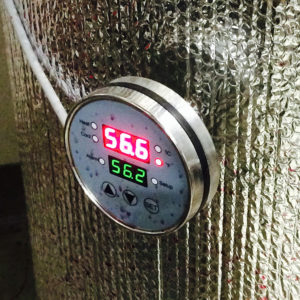 temperature gauge on steel tank reading 56.6 degrees