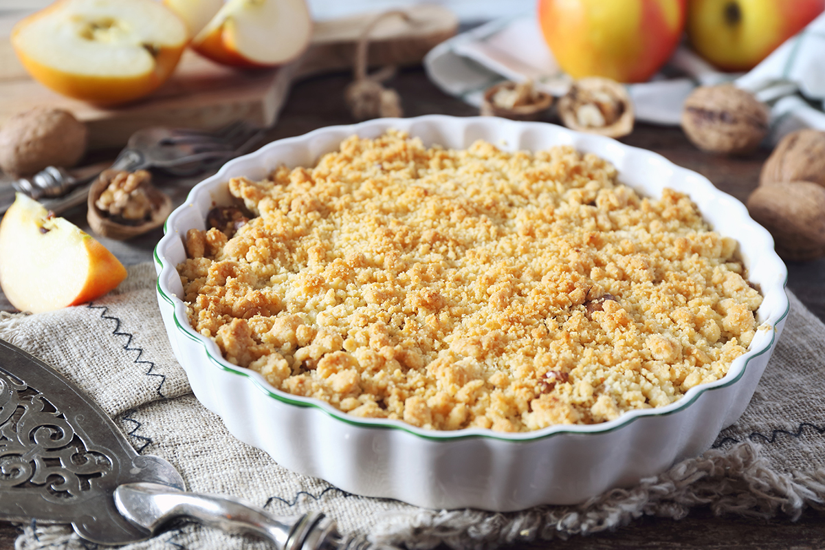 pie dish filled with apples and walnuts and baked