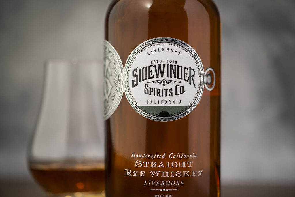 bottle of sidewinder rye whiskey with light background