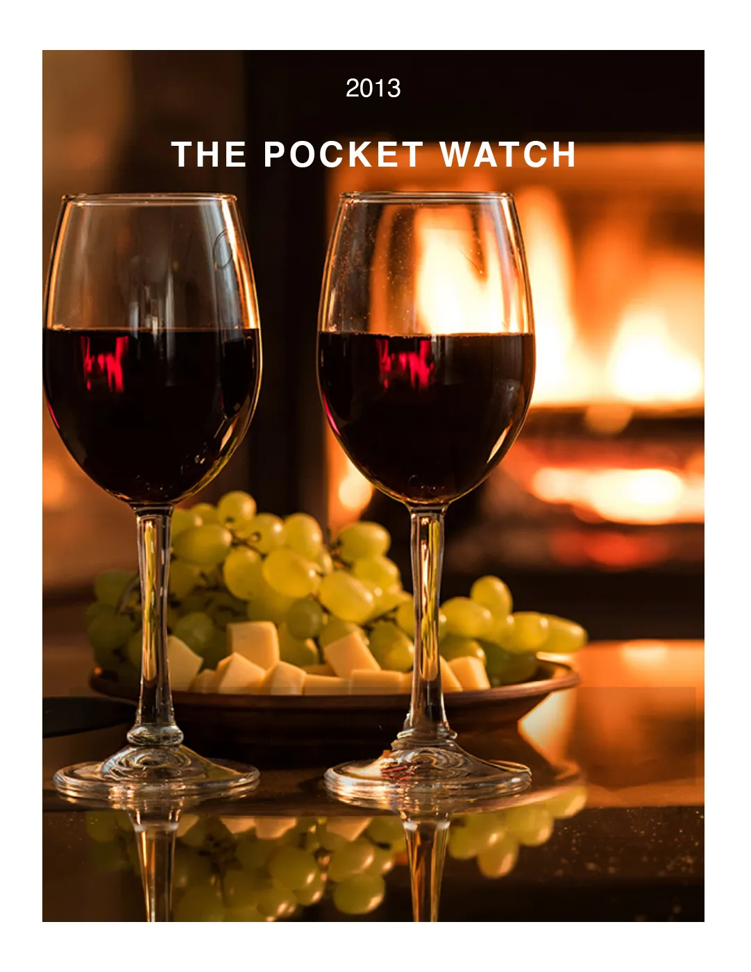 Pocketwatch 2013 archive cover featuring two glasses of red wine by a warm fireplace